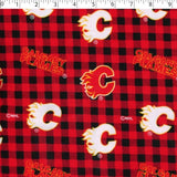 medium weight brushed NHL cotton in the print of Calgary flamers on a red and black buffalo check background